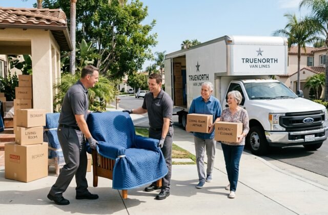 Professional movers helping a senior couple move from a Southern California home with labeled boxes and padded furniture