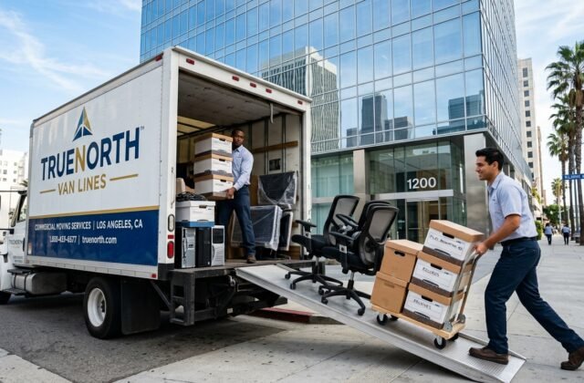 Professional movers loading packed office equipment into a truck in Los Angeles